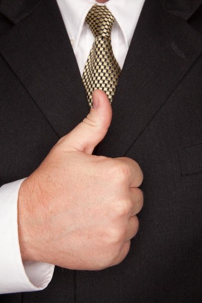586411-businessman-gesturing-thumbs-up-with-hand
